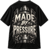 Black streetwear T-shirt featuring a metallic industrial graphic with chains and the bold, cracked-stone text Made By Pressure on the back.